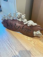 Front view showing plaque, bears, and "Welcome" text