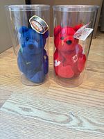 Front view of blue and red Gretzky plush bears in clear tubes