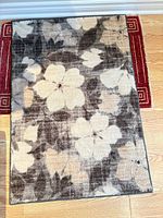 Full view of floral synthetic rug on floor