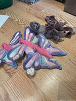 Front view of all five plush toys on floor