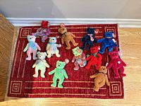 Group shot of 13 Ty Beanie Babies bears on red rug