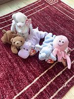 Group shot of five Ty Beanie Babies on red rug