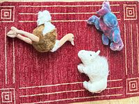 All three plush animals on red rug