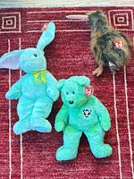 Group shot of three Ty Beanie Buddies on red rug