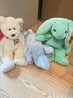 Group shot of three Ty Beanie Buddies plush: Canada bear, blue dog, mint bunny