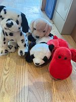 Front view of all four Ty Beanie Buddies plush animals on wood floor