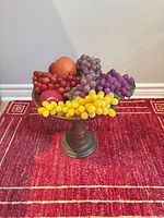 Wood pedestal bowl with artificial fruit arrangement top view