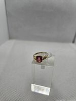 Front view of 10K gold ring showcasing pink stone and band