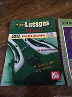 Front cover of First Lessons: Violin book showing title and CD/DVD note