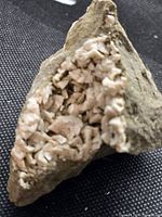 Overall view of dolomite crystal specimen on black surface