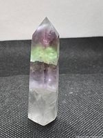 Front view of fluorite point standing upright