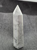 Front view of polished howlite tower showing veining and shape