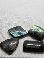 Four labradorite cabochons on white background