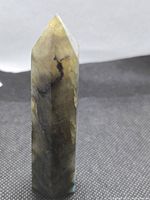Full view of labradorite point standing upright