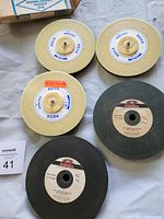 Five lapidary wheels front view showing labels and hubs