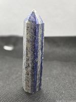Front view of lapis lazuli crystal point standing upright