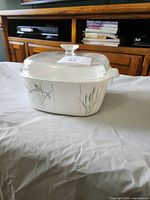 Square CorningWare casserole with floral pattern and lid