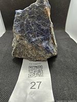 Front view of sodalite specimen on black fabric