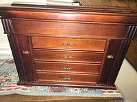 Front view showing four drawers and side doors of wooden jewelry box