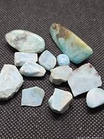 Group of Larimar stones on dark fabric background