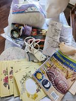 Overview of entire lot showing fiberfill bag, ribbons, magazine, cards, palette, heat tool, pattern, bird blank, mannequin head