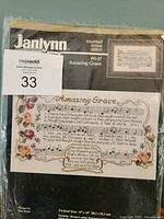 Front of sealed Janlynn Amazing Grace kit showing brand, design image and lot tag