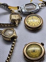 Five vintage watches displayed