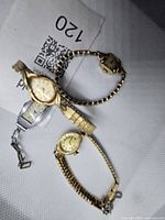 All four watches grouped on neutral background