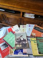 Overall shot of all piano music books spread on surface