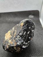 Overall view of snowflake obsidian showing black glassy matrix with white inclusions