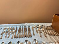 Full layout showing knives, spoons, forks on cloth