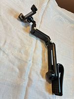 Full view of articulated black clamp mount