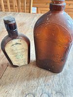 Two amber glass bottles side by side on table