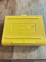 Closed yellow plastic Arrow staple gun kit case