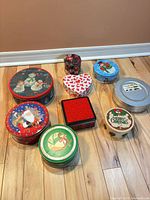Group view of all tins on wood floor
