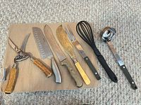 All seven kitchen utensils laid out on mat