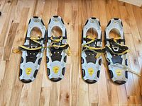 Four Atlas Series 7 snowshoes laid out to show full view of both pairs