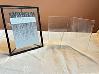 Azzure Home floating frame and acrylic tri-fold display side by side