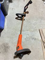 Full view of string trimmer showing overall length, shaft, handle and guard