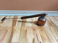 Full view of sprayer showing copper reservoir, steel pump tube and wood handle