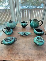 Full set of eight Blue Mountain Pottery turquoise drip-glaze serveware pieces displayed on table