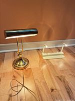 Brass piano lamp and white dual-head accent light powered on