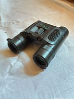 Full view of folded black Brunton compact binoculars