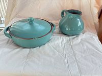 Casserole with lid and pitcher side by side