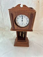Pocket watch inserted in wooden stand front view