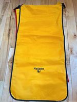 Full view of yellow H2Zero dry bag laid flat showing black binding and logo