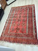 Full view of the entire rug laid flat showing overall pattern, colors and wear