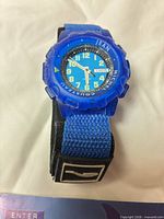 Front view of blue Jean-Michel Cousteau wristwatch showing dial and strap