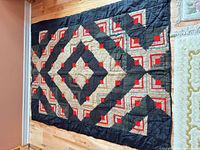 Full view of Log Cabin quilt laid flat showing overall pattern and colors
