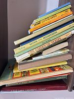 Stack of assorted children’s books showing spines and titles